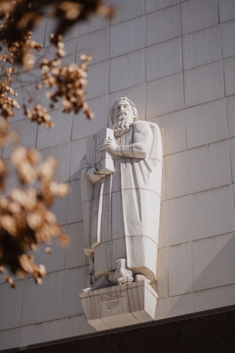 A relief statue of a man holding the 10 commandments